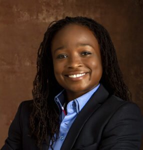 Portrait of Ashley Butler posing inside a photo studio.